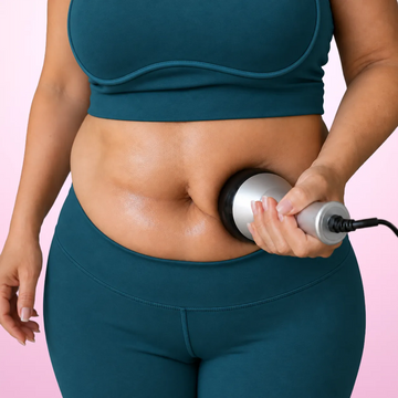 Woman using the 9-in-1's 40K cavitation head on her belly